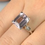 A kunzite single-stone ring, with marquise-shape diamond accents.