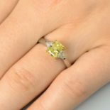 A platinum rectangular-shape Fancy Yellow diamond and triangular-shape diamond three-stone ring,