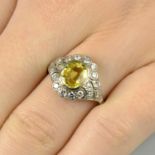 A yellow sapphire and diamond cluster ring.Sapphire calculated weight 1.57cts,