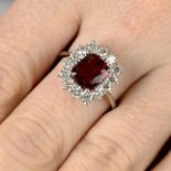 An orangey Red spinel and diamond cluster ring.With report 1910SNR0442,