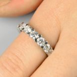 A brilliant-cut diamond tapered full eternity ring.