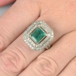 An emerald and diamond cluster ring.