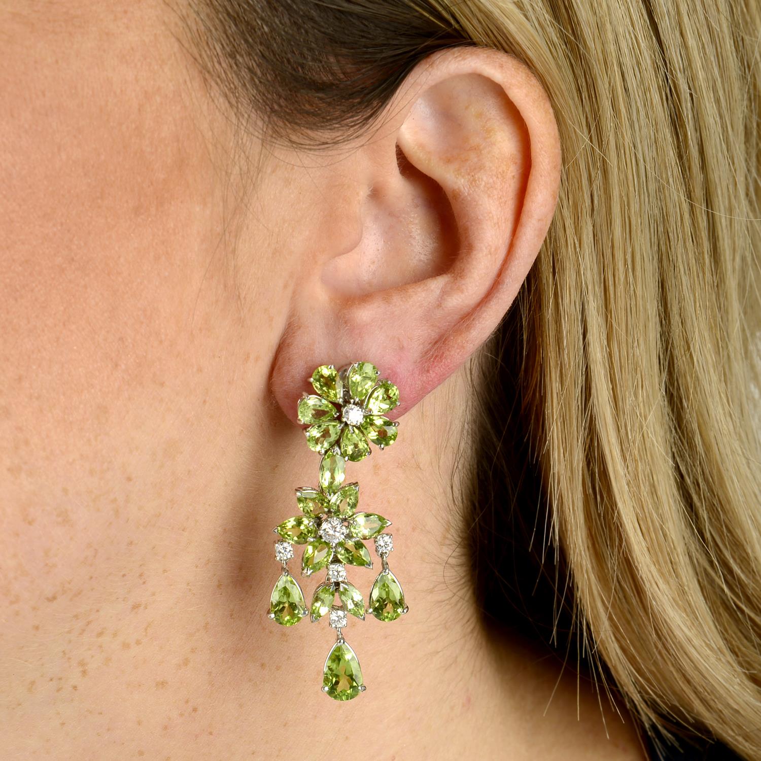 A pair of 18ct gold peridot and diamond floral cluster drop earrings.Estimated total diamond weight