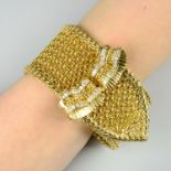 A mid 20th century 18ct gold mesh-link buckle bracelet, with brilliant-cut diamond scroll clasp.