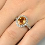 An orange sapphire and diamond cluster ring.Sapphire calculated weight 2cts,