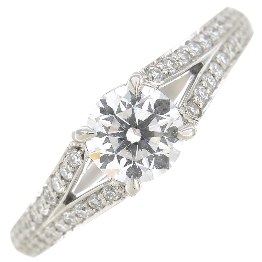 A platinum brilliant-cut diamond single-stone ring, with diamond chevron shoulders. - Image 6 of 6