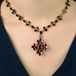 A foil back garnet floral pendant, on garnet foliate chain.Length of pendant 4.5cms.