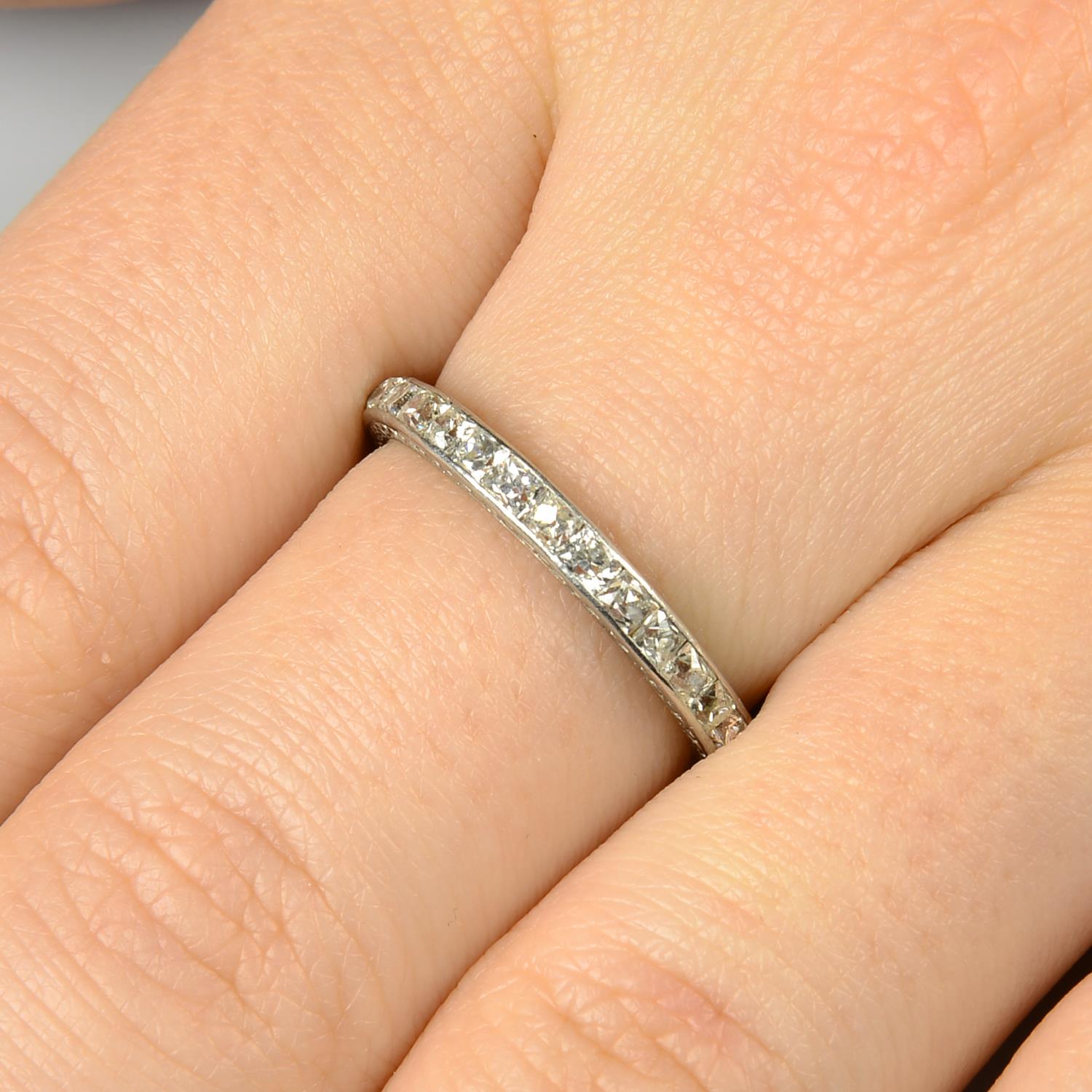 An early 20th century platinum square-shape old-cut diamond full eternity ring,