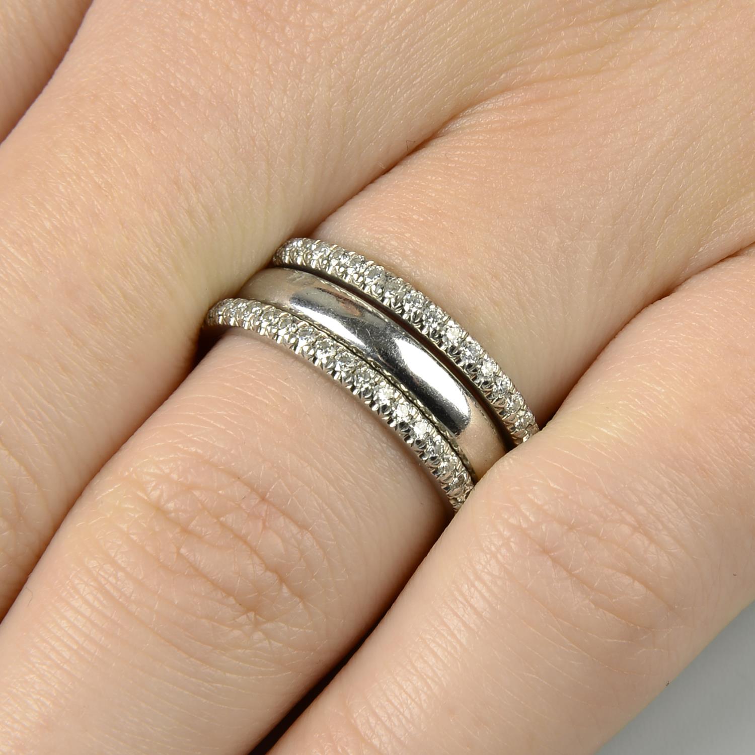 A band ring and two brilliant-cut diamond full eternity rings,