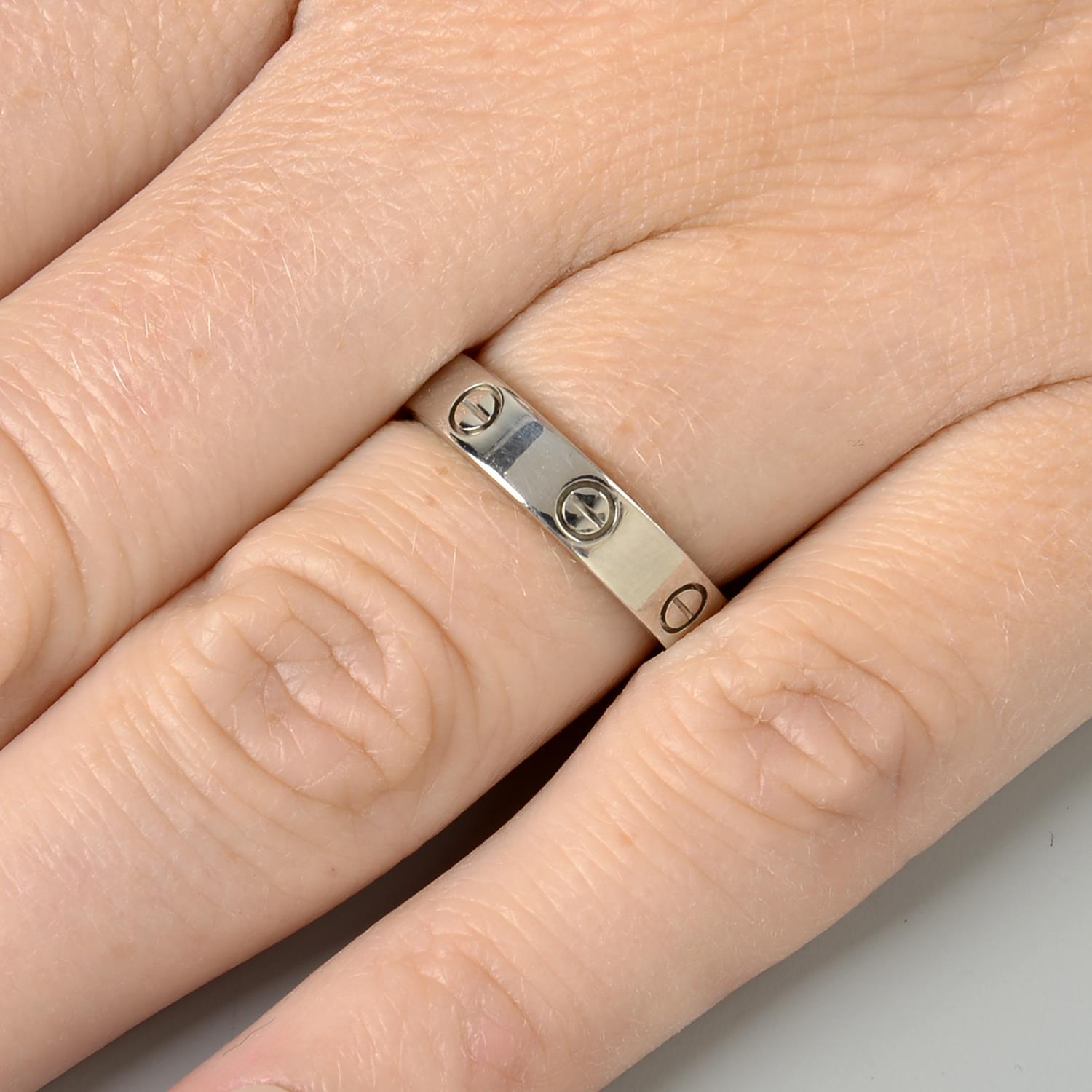 An 18ct gold diamond accent 'Love' ring, by Cartier.Swiss convention marks.