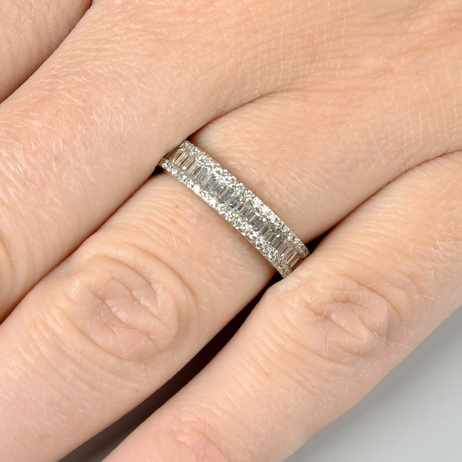 An 18ct gold baguette and brilliant-cut diamond full circle eternity ring.Estimated total diamond