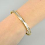 A baguette-cut diamond line hinged bangle.