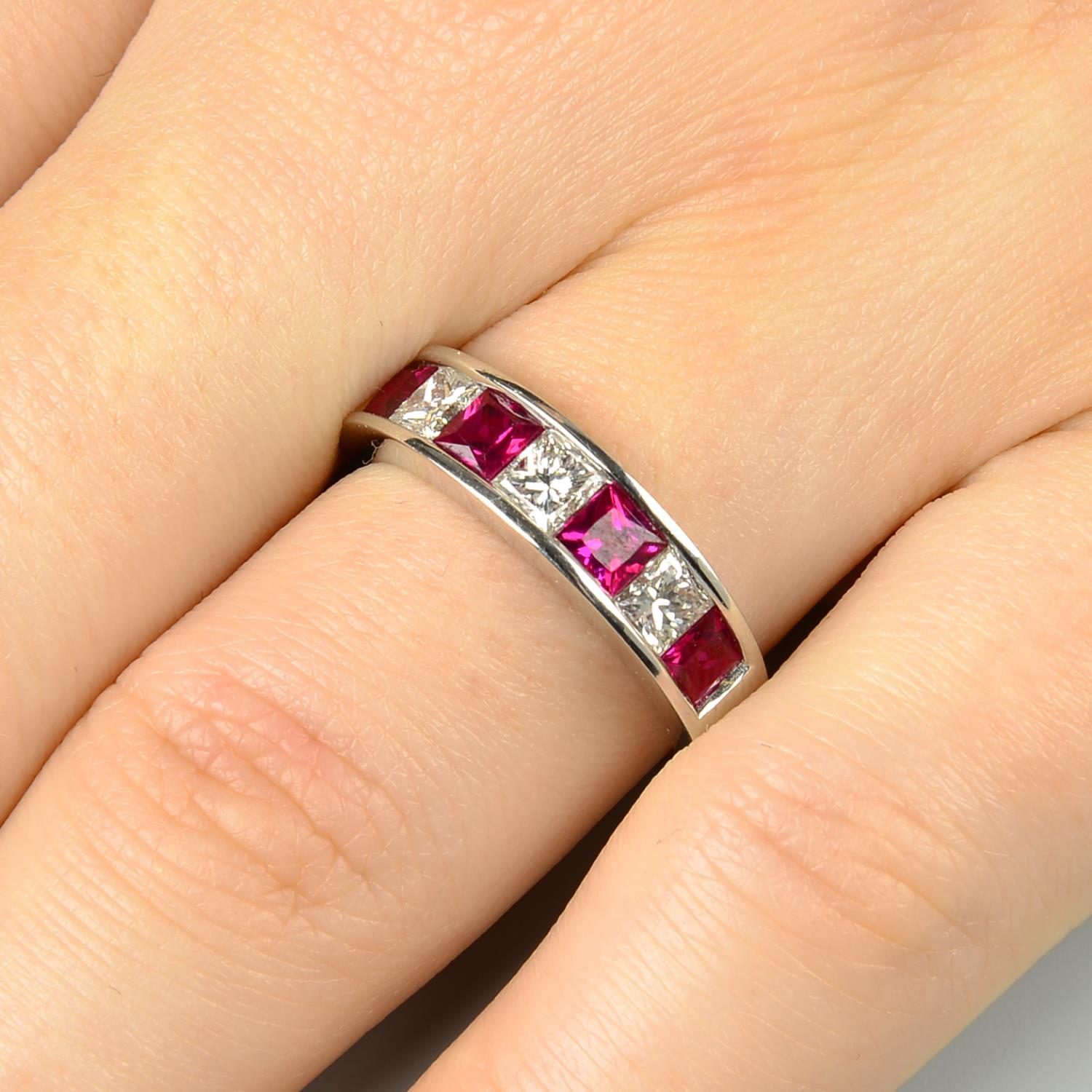 An 18ct gold square-shape ruby and diamond half eternity ring.