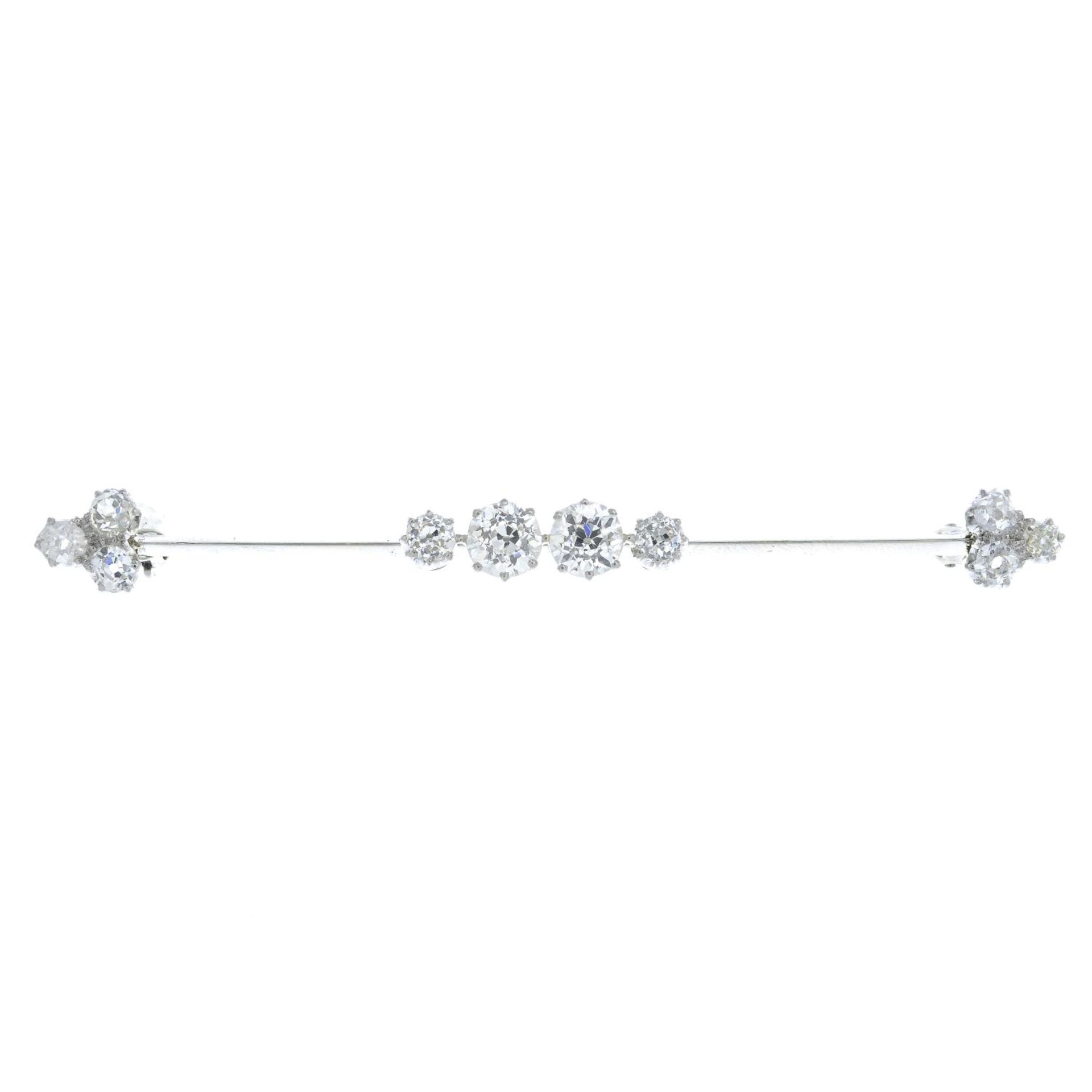 An early 20th century gold old-cut diamond bar brooch.Estimated total diamond weight 1.50cts,