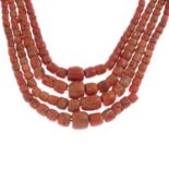 A coral four-row bead necklace.Clasp stamped 750.Length 64cms.