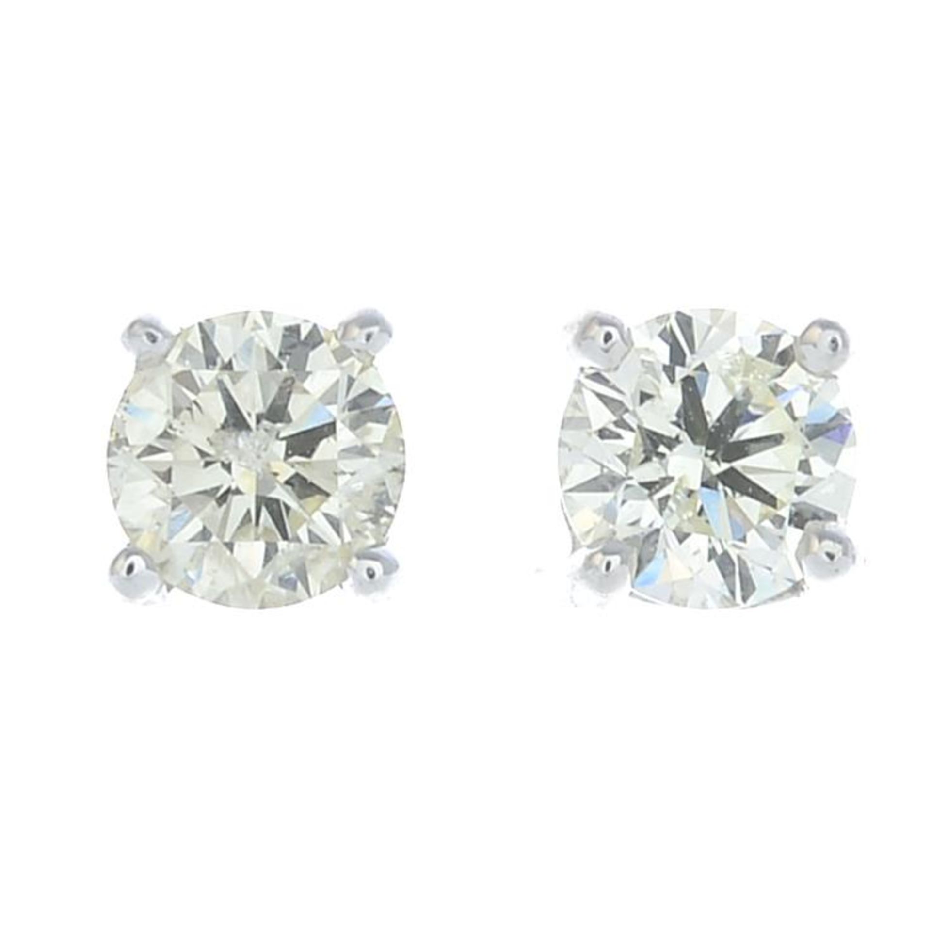 A pair of brilliant-cut diamond earrings.Estimated total diamond weight 0.65ct,