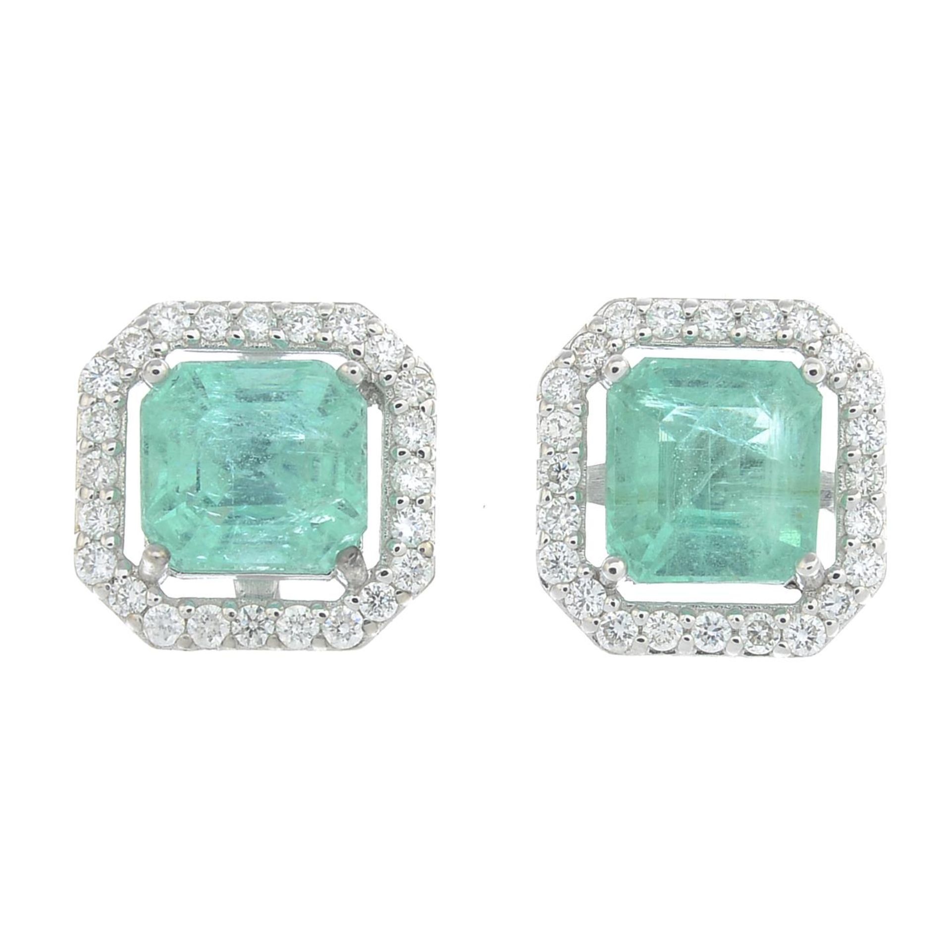 A pair of emerald and brilliant cut diamond cluster earrings.Estimated total diamond weight