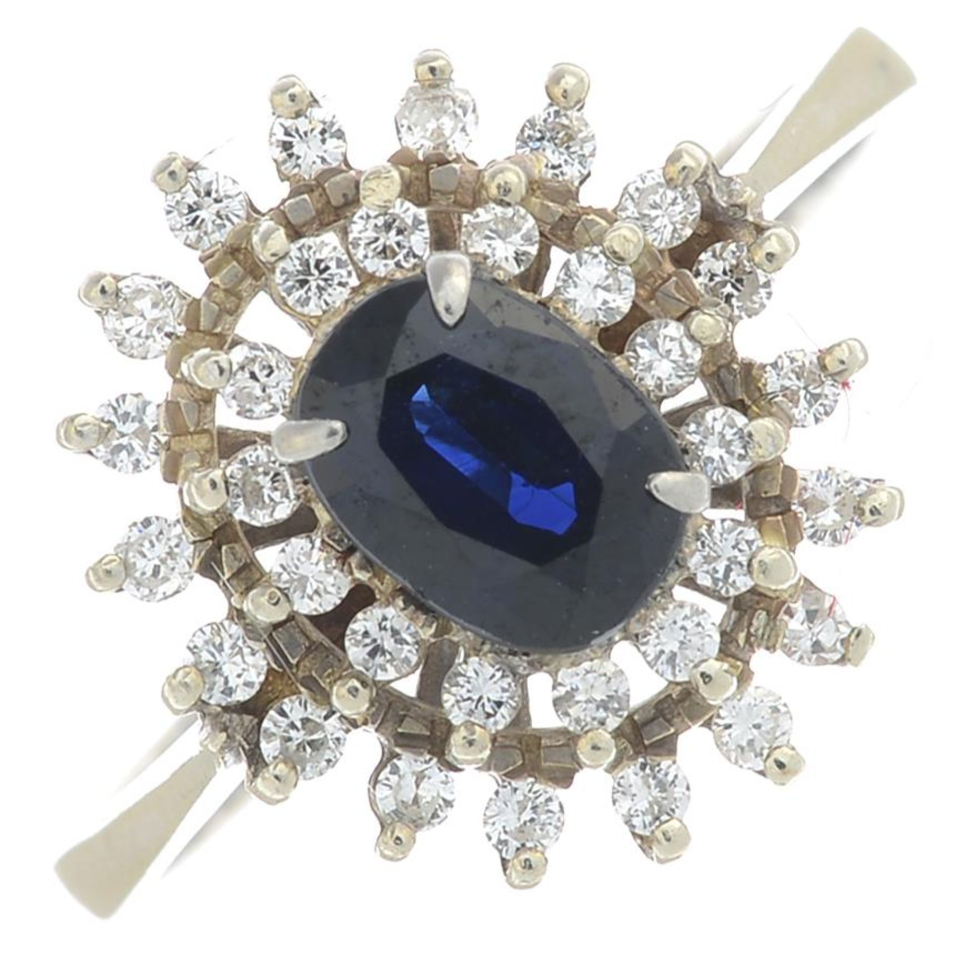 An 18ct gold sapphire and diamond cluster ring.Estimated total diamond weight 0.35ct.Import marks