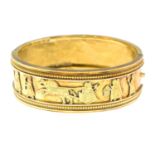 A late Victorian 15ct gold Assyrian Revival hinged bangle.Inner diameter 5cms.