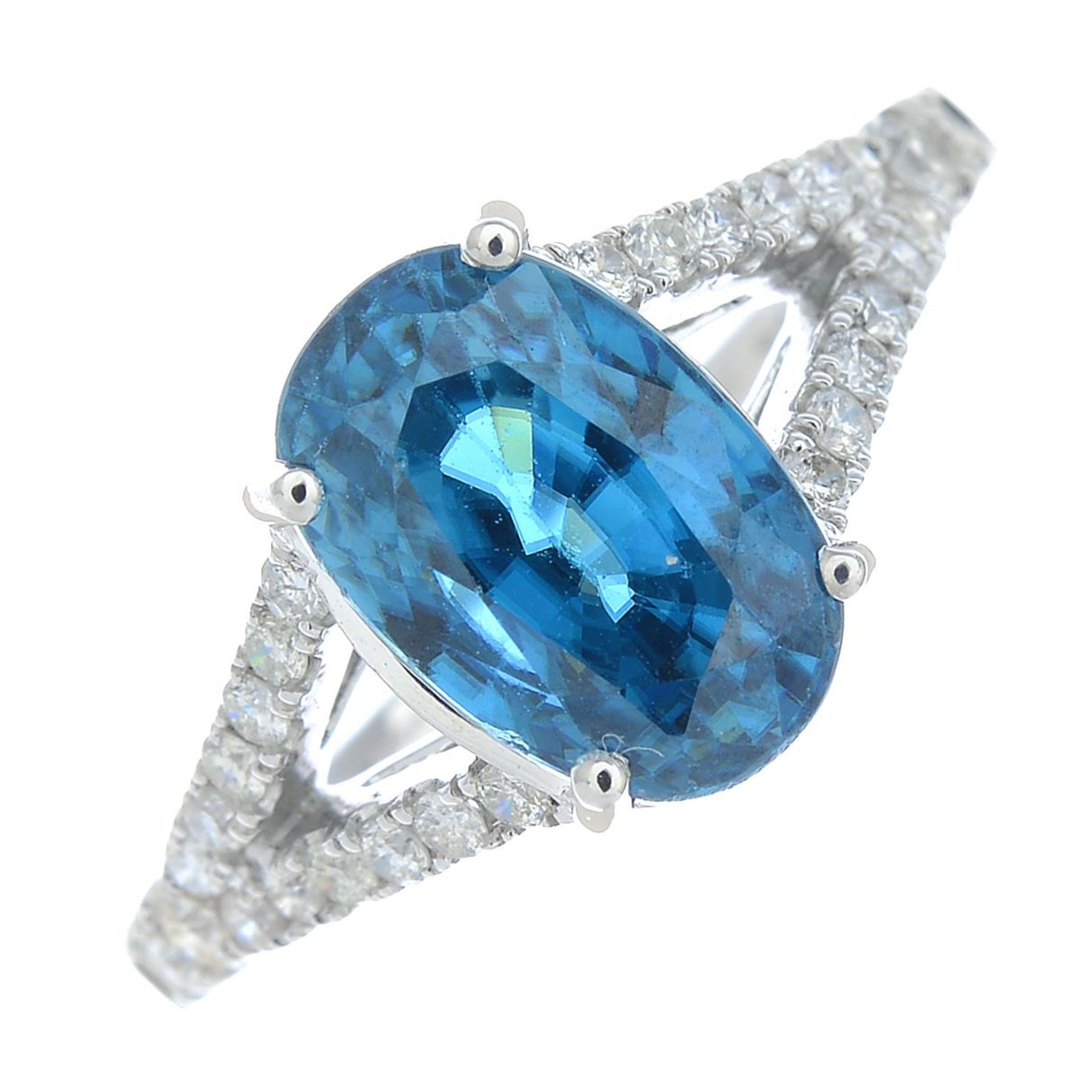A blue zircon and brilliant-cut diamond dress ring.Zircon calculated weight 3.31cts,