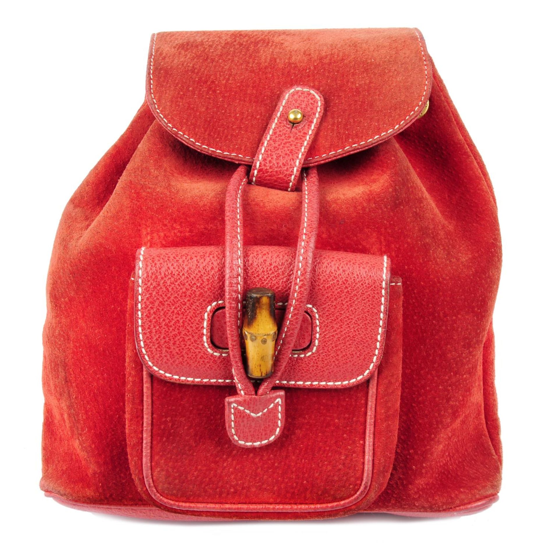 GUCCI - a red suede and leather bamboo backpack.