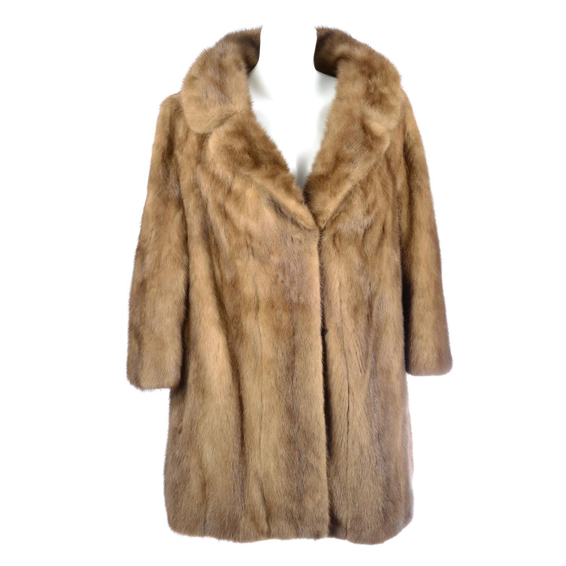 A three-quarter length pastel mink coat.