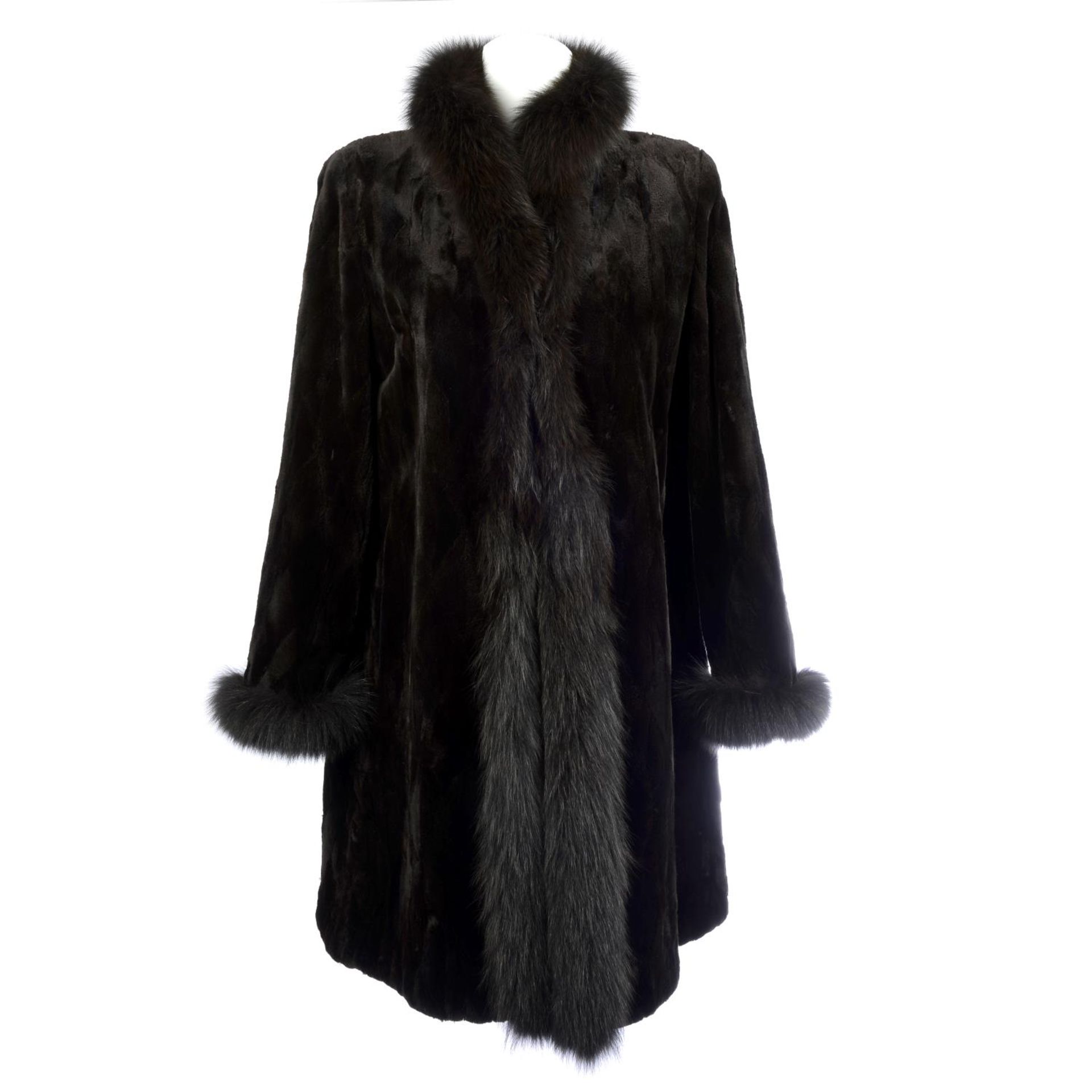 A reversible sheared mink coat with fox fur trim.