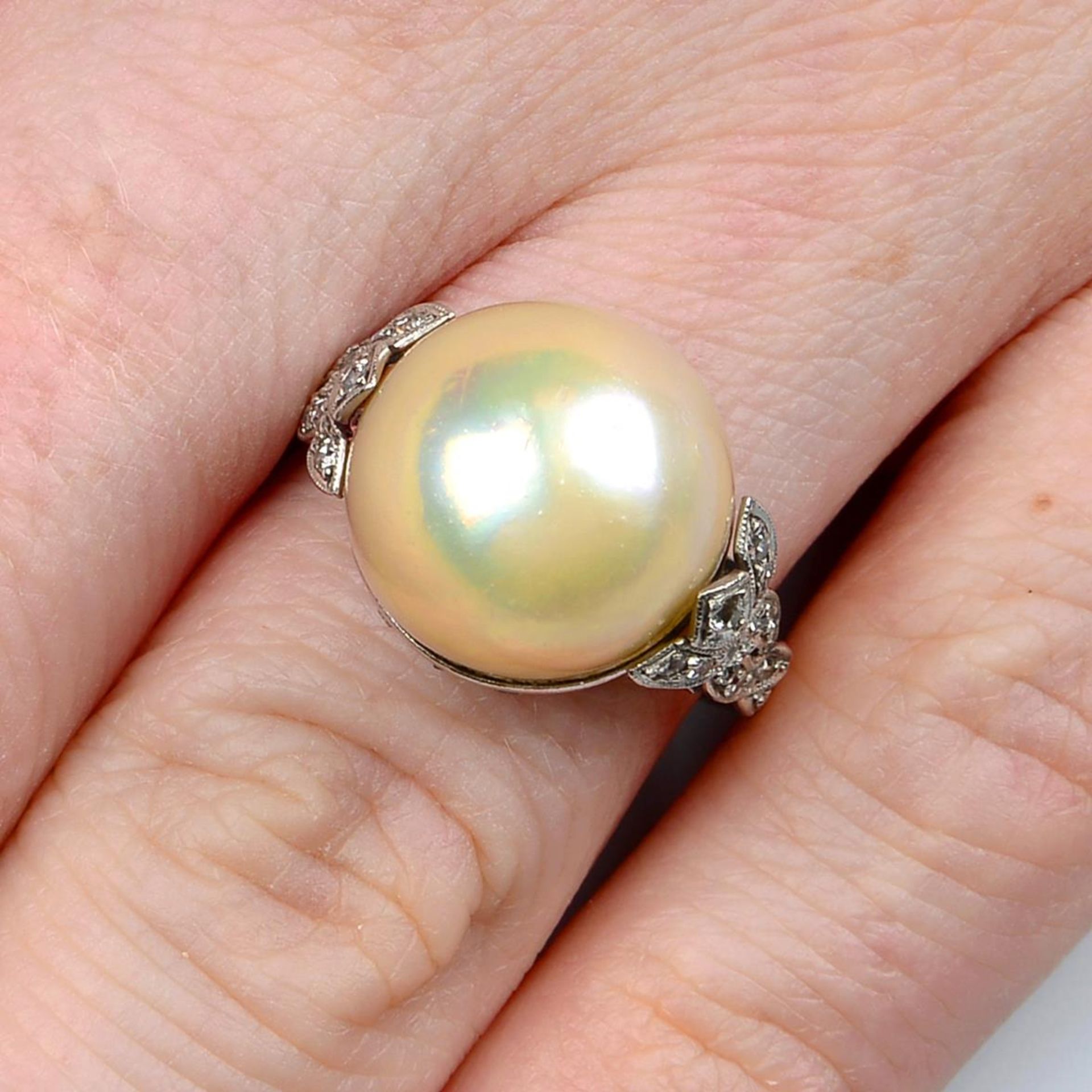 A mid 20th century platinum split pearl and vari-cut diamond dress ring.Estimated dimensions of