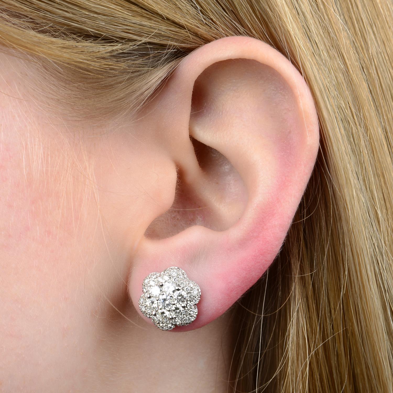 A pair of 18ct gold diamond floral cluster earrings.