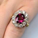 An 18ct gold garnet and brilliant-cut diamond cluster ring.Estimated total diamond weight 0.75ct,