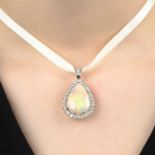 An 18ct gold opal and brilliant-cut diamond cluster pendant.Estimated dimensions of opal 23.3 by