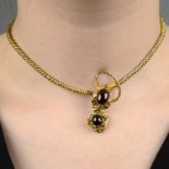 A late 19th century gold garnet snake necklace, with garnet heart locket drop.Length 34.5cms.
