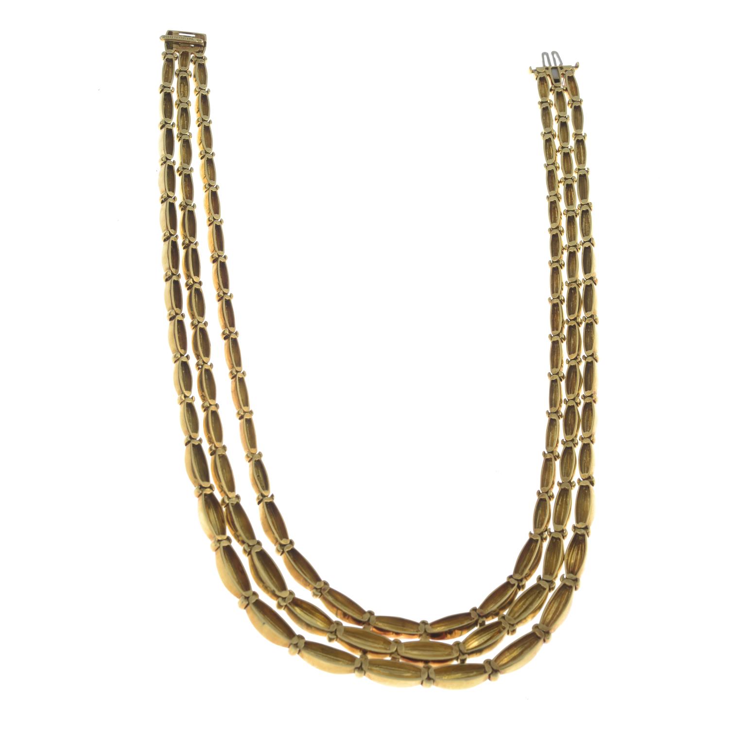 A grooved link, three-strand necklace, by Tiffany & Co.Stamped 750. - Image 3 of 5