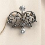 A late Victorian silver and gold old and rose-cut diamond floral brooch.Principal two diamonds