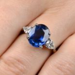 A platinum oval-shape sapphire and pear-shape diamond three-stone ring.Sapphire calculated weight