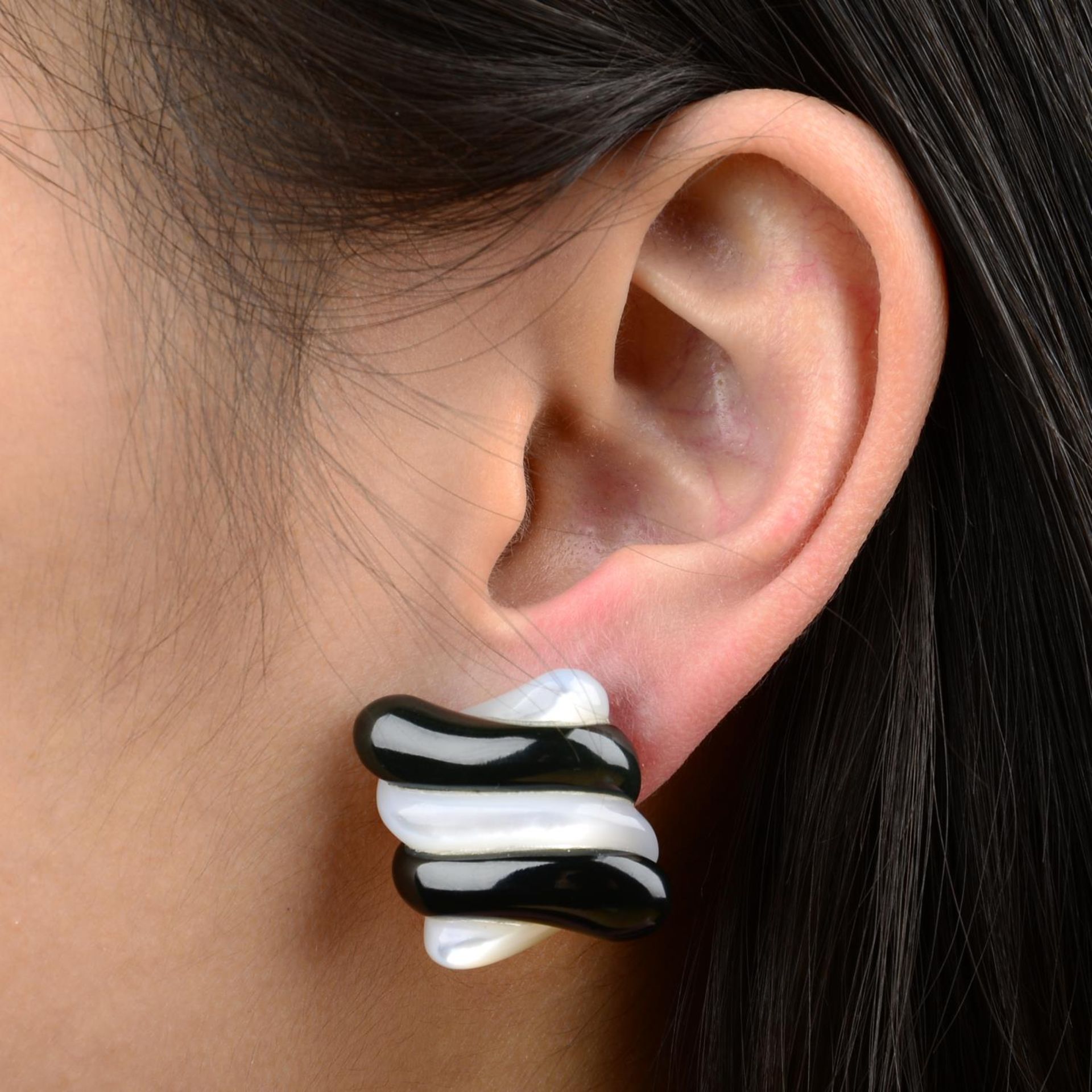 A pair of carved mother-of-pearl and black jade earrings, by Angela Cummings.Stamped 750.