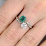 An early 20th century platinum emerald and old-cut diamond two-stone crossover ring,