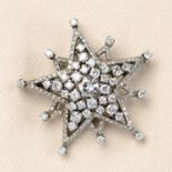 A mid 20th century gold diamond star brooch.