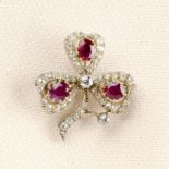 An early 20th century silver and gold, ruby and old-cut diamond shamrock pendant.