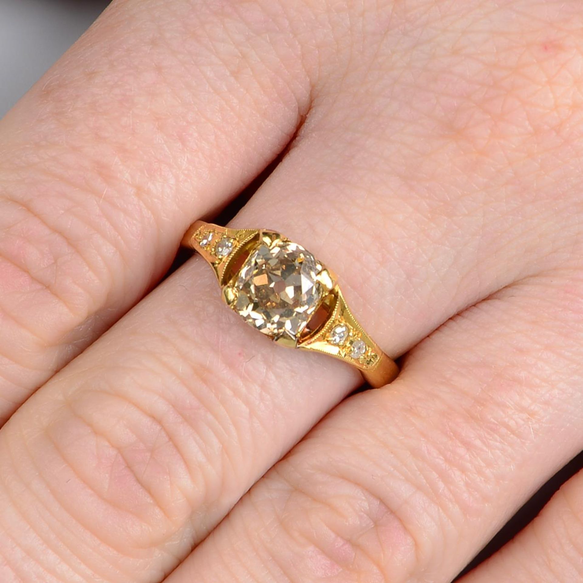 An old-cut 'brown' diamond single-stone ring, with diamond shoulders.