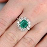 A platinum, emerald and vari-cut diamond cluster ring.Emerald calculated weight 2.04cts,