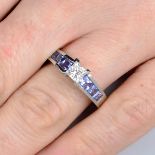 A platinum diamond single-stone ring, with square-shape sapphire line gallery and shoulders.