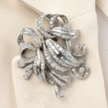 A mid 20th century single and baguette-cut diamond scrolling double clip brooch.Estimated total