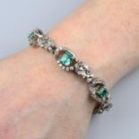 A mid 20th century platinum emerald and diamond floral bracelet.