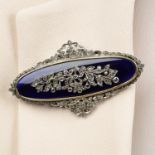 A blue glass brooch, with diamond point and sapphire floral motif.Length 7.5cms.