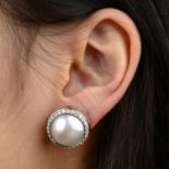 A pair of mabe pearl and diamond cluster earrings.