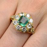 An 18ct gold emerald and circular-cut diamond cluster ring.Emerald calculated weight 0.96ct,