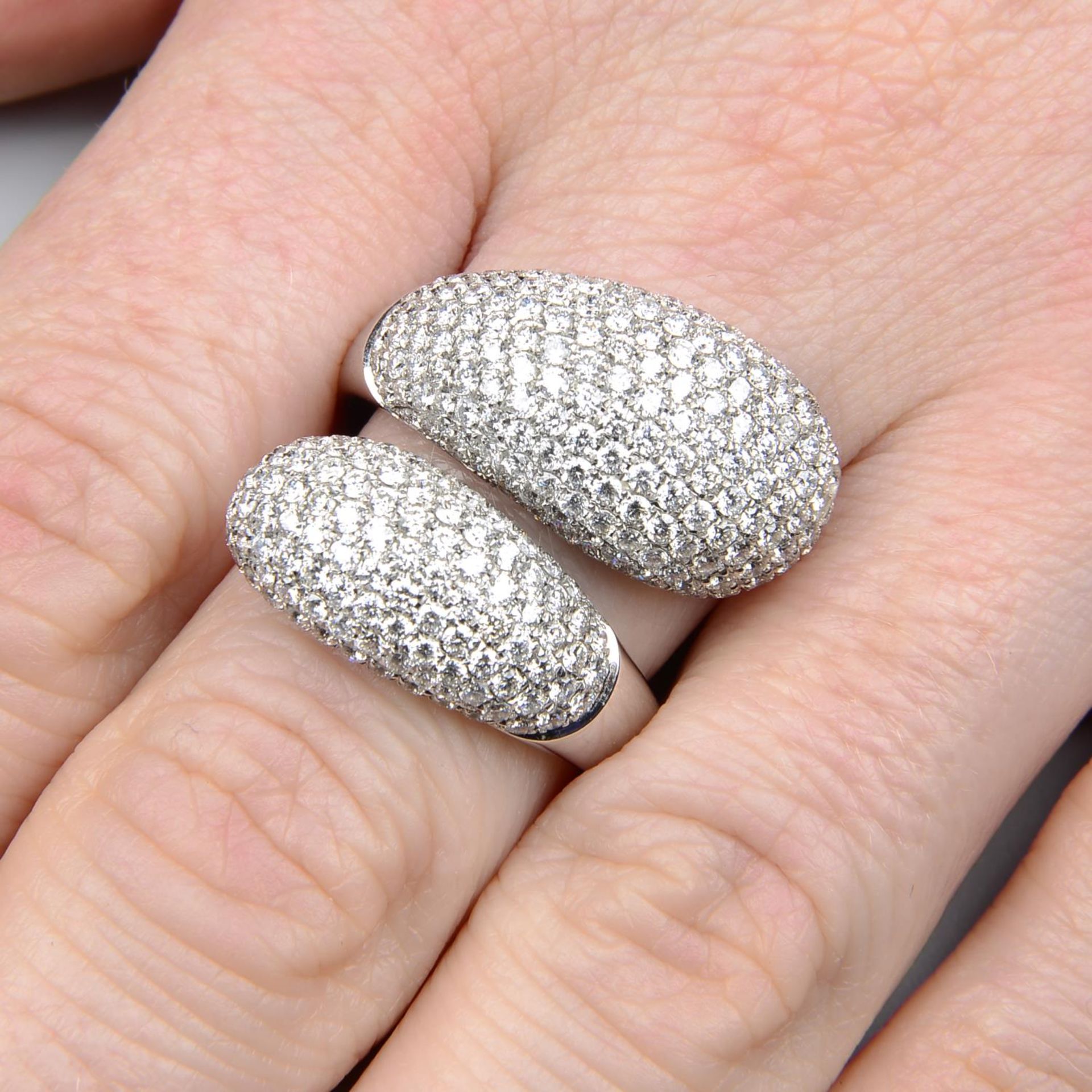 A pave-set diamond crossover dress ring.