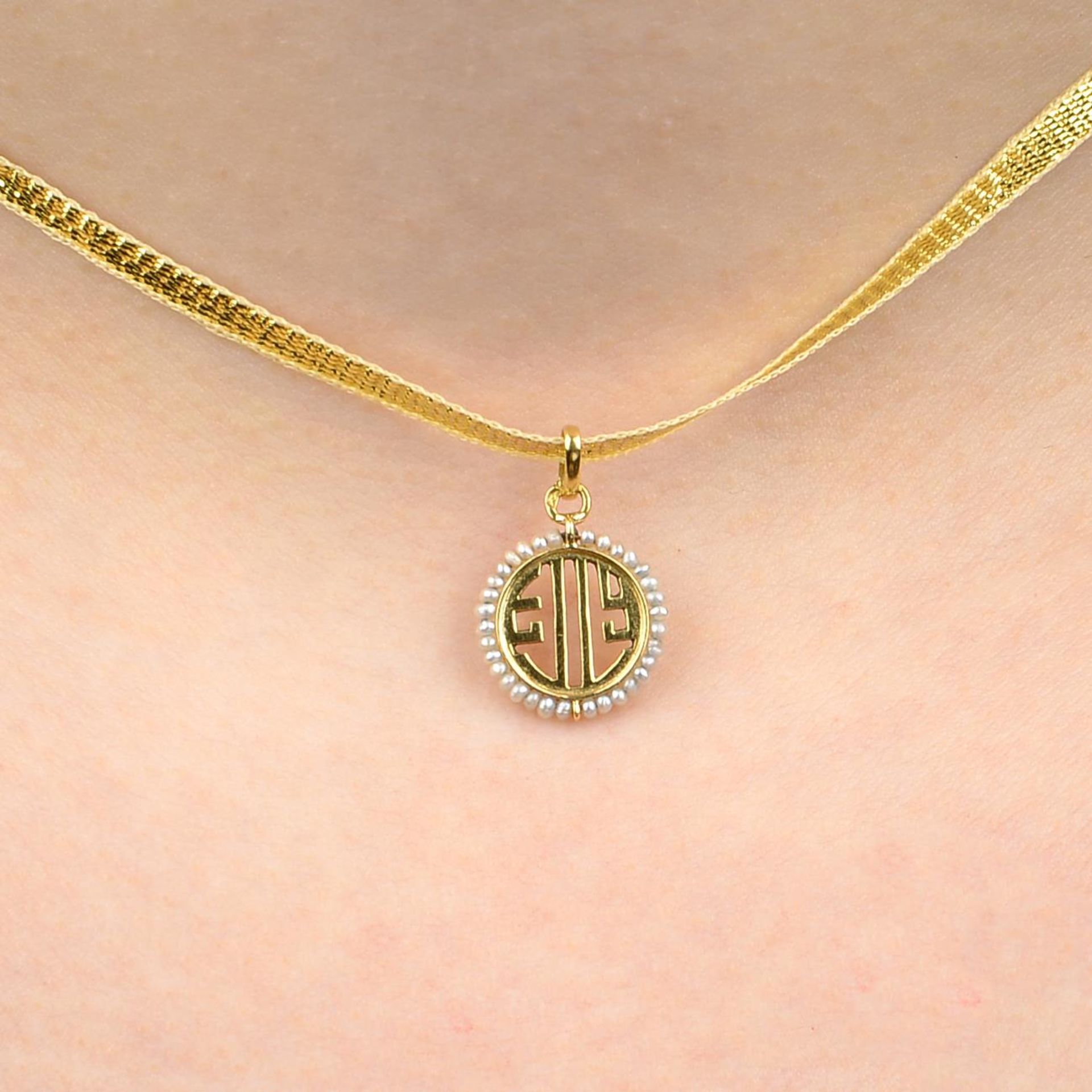 An early 20th century 18ct gold seed pearl pendant charm, by Cartier.French assay mark.