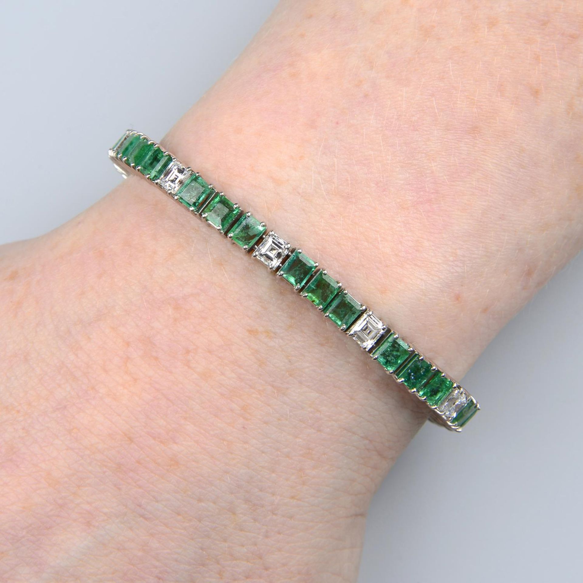 An emerald bracelet, with square-shape diamond highlights.